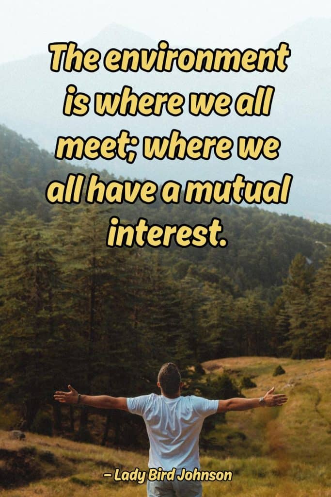 A person standing outdoors with arms outstretched in a natural environment, emphasizing connection w.